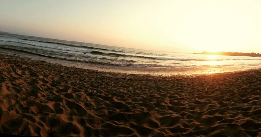 beach, sea, horizon over water, sand, shore, water, sunset, scenics, tranquil scene, tranquility, beauty in nature, sky, sun, nature, wave, idyllic, sunlight, vacations, coastline, remote, tourism, outdoors, travel destinations, orange color, non-urban scene, calm, no people