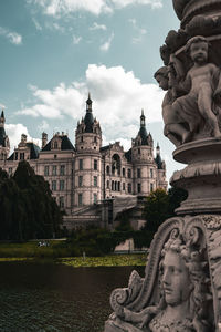 Statue of historic building against sky