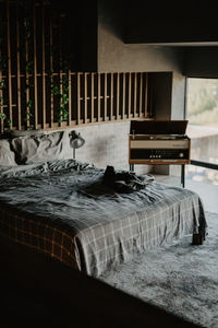 View of cat relaxing on bed at home