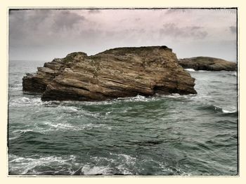 Scenic view of sea against cloudy sky