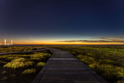 Sea shore pathway bridge under sunset glow with rosy clouds. gaomei wetlands, taichung city, taiwan