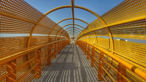 Footbridge against clear sky