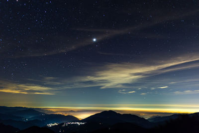 Scenic view of silhouette mountains against sky at night