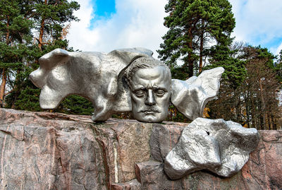 Low angle view of statue against rock