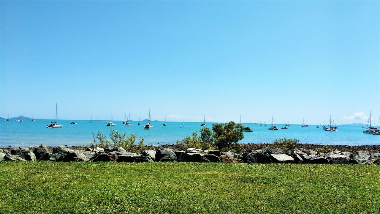 SAILBOATS ON SEA AGAINST CLEAR SKY