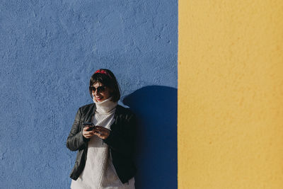 Woman standing against wall