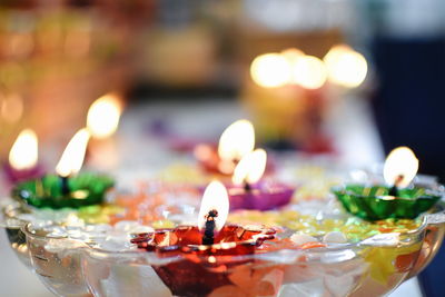 Close-up of lit tea light candles in temple