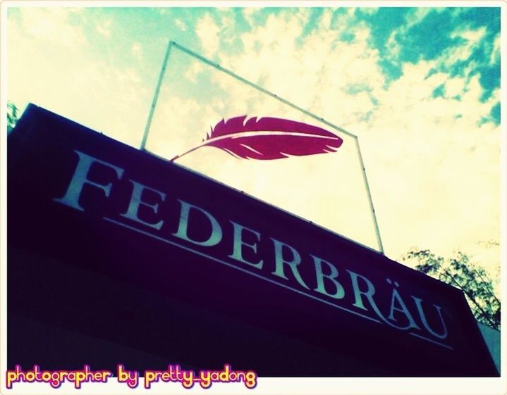 low angle view, flag, identity, patriotism, sky, text, national flag, western script, communication, road sign, american flag, guidance, blue, pole, directional sign, red, cloud, transfer print, sign, cloud - sky