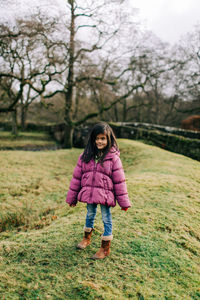 Full length of girl standing on field