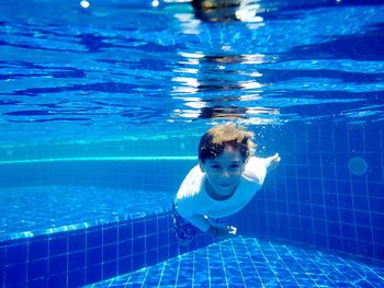 Portrait of boy swimming in pool