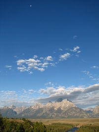 Scenic view of mountains against blue sky