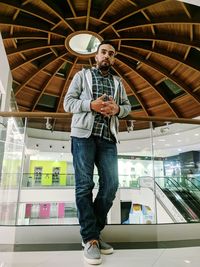 Full length of man standing at shopping mall