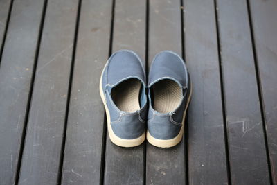High angle view of shoes on boardwalk