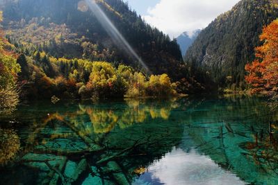 Scenic view of lake by mountain during autumn