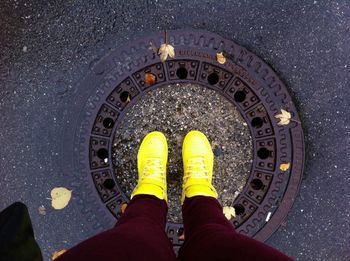 Low angle view of human legs in yellow trainers