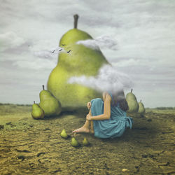 Digital composite image of woman sitting by pear on land