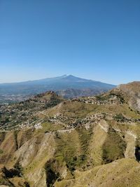 View of mountain range against blue sky