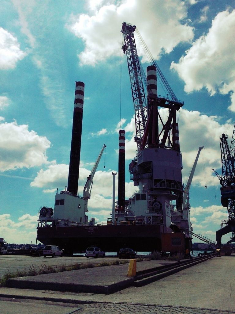 sky, crane - construction machinery, built structure, cloud - sky, architecture, connection, industry, crane, development, cloud, construction site, low angle view, fuel and power generation, cloudy, construction, transportation, commercial dock, no people, outdoors, electricity pylon