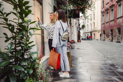 Side view of young woman walking on street