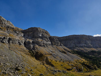 Scenic view of mountain against blue sky