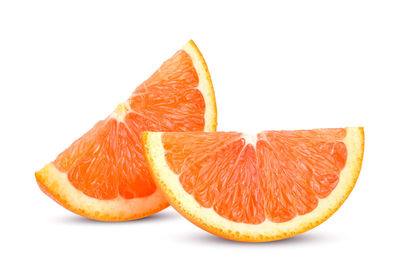 Close-up of orange slice against white background