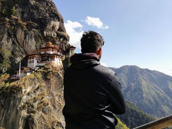 Rear view of man standing on rock