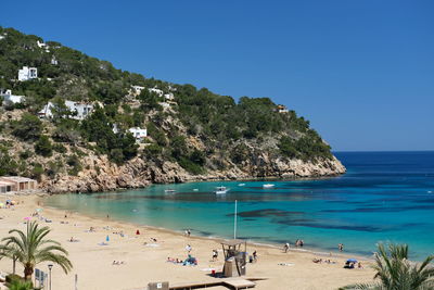 Scenic view of beach against clear blue sky