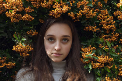 Portrait of a beautiful young woman with autumn leaves