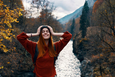 Young woman standing in park during autumn