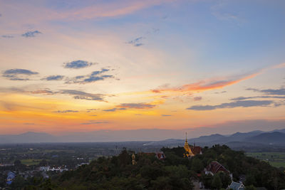 High angle view of buildings in city during sunset