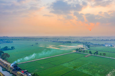 High angle view of agricultural field against sky during sunset