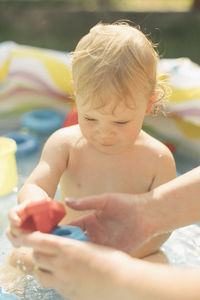 Portrait of cute boy playing with toy at home