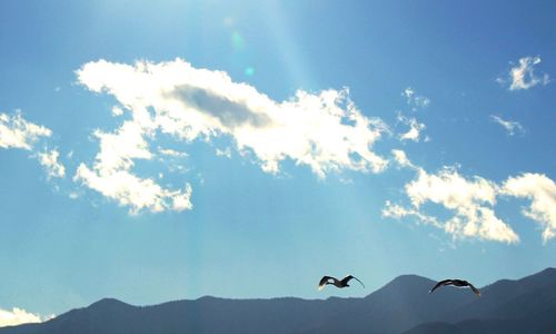 Low angle view of mountain against blue sky