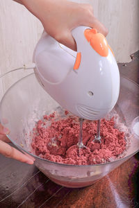 Cropped image of person mixing ingredients in bowl