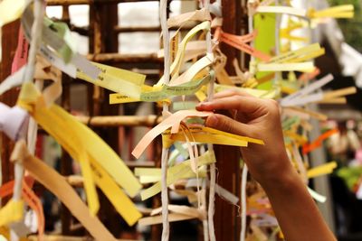 Cropped image of person with fortune paper