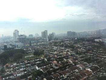 High angle view of buildings in city against sky