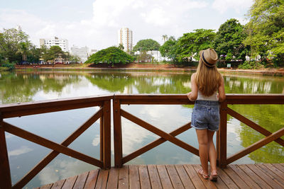 Full length back view of young woman in the urban park bosque dos buritis in goiania, goias, brazil.
