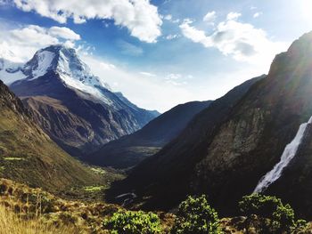 Scenic view of mountains against cloudy sky