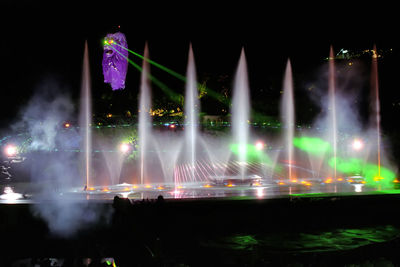 Illuminated fountain at night