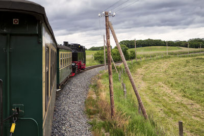 Train on railroad track against sky