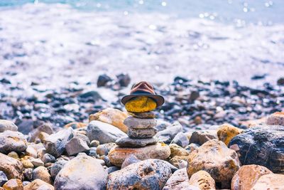 Stack of pebbles on beach against sky