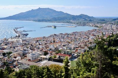 High angle view of townscape and sea against sky