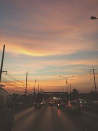 Cars on road at sunset