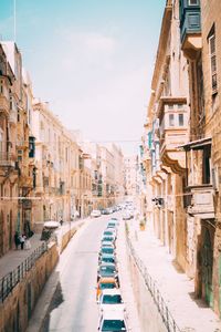 Street amidst buildings in city against sky