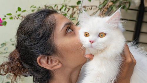 Close-up of woman with cat