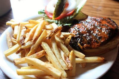 Close-up of fries with meat and vegetables on plate