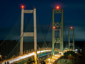 Low angle view of suspension bridge at night