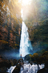 Scenic view of waterfall against sky