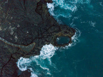 High angle view of rock in sea