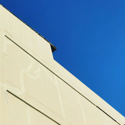 Low angle view of building against clear blue sky